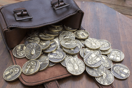 A leather coin pouch with fantasy coins spilling out